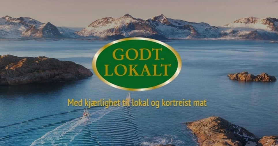 Godt lokalt logo i gult med grønnbakgrunn i midten av bildet. Under står det med gul skrift "med kjærlighet til lokal og kortreist mat". Bakgrunnen for logo er et bilde med fjell og hav,